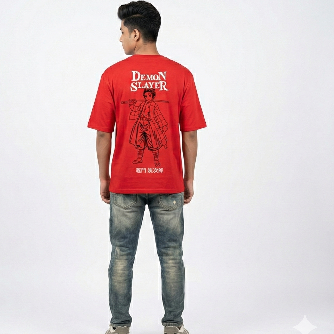 Person wearing a red 'Demon Slayer' t-shirt with a character design on the back, standing against a white background.